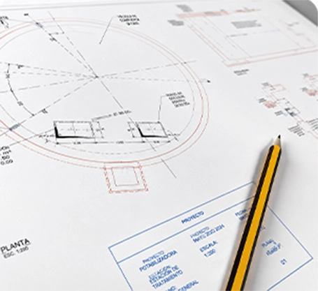 Plano arquitectónico con lápiz sobre mesa
