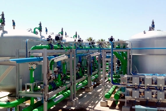Planta industrial con tanques y tuberías verdes